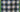 gingham patterned quilt in forest